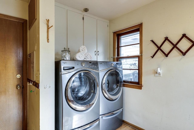 laundry room featuring washer and dryer and cabinet space