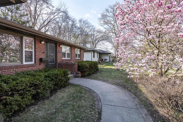 exterior space with a yard and brick siding