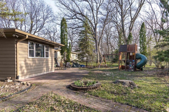 view of yard with fence, a patio area, and a playground