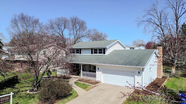 2607 King James Way, Fitchburg, WI 53719 - traditional home with a chimney, driveway, an attached garage, a porch, and roof with shingles