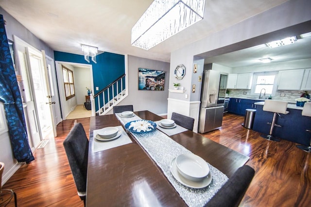 2607 King James Way, Fitchburg, WI 53719 - dining area with stairway, a chandelier, and dark wood-type flooring