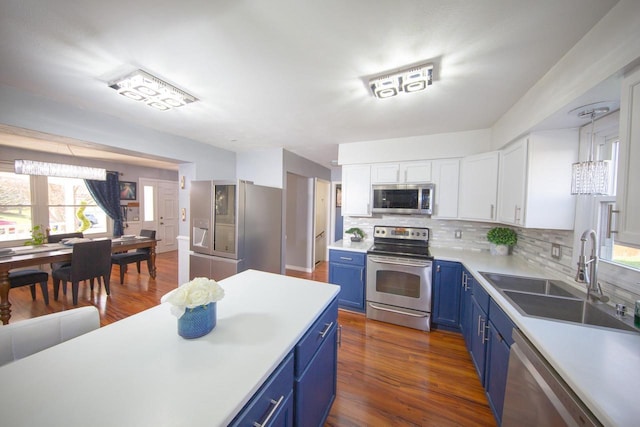 2607 King James Way, Fitchburg, WI 53719 - kitchen with blue cabinetry, appliances with stainless steel finishes, a sink, and light countertops