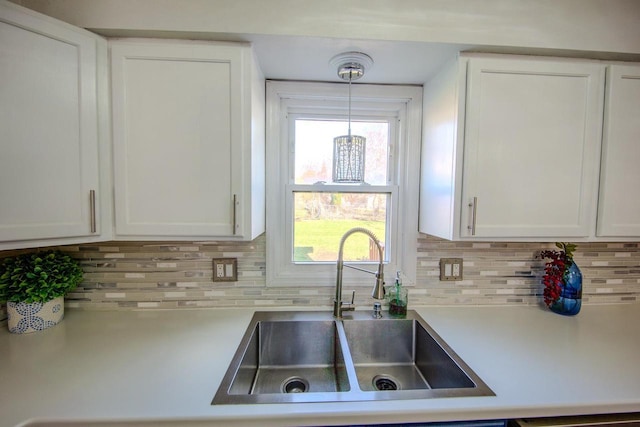 2607 King James Way, Fitchburg, WI 53719 - kitchen with light countertops, tasteful backsplash, white cabinetry, and a sink
