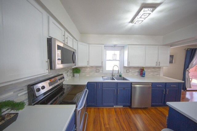 2607 King James Way, Fitchburg, WI 53719 - kitchen with a sink, decorative backsplash, stainless steel appliances, blue cabinetry, and white cabinetry
