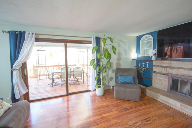2607 King James Way, Fitchburg, WI 53719 - sitting room featuring a fireplace, wood finished floors, and baseboards