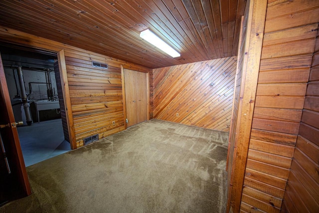 2607 King James Way, Fitchburg, WI 53719 - unfurnished room featuring wooden walls, visible vents, carpet flooring, and wood ceiling