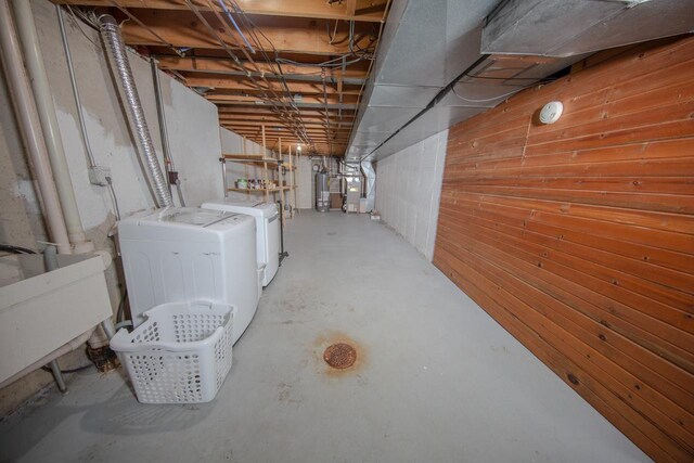 2607 King James Way, Fitchburg, WI 53719 - unfinished below grade area with washer and dryer, water heater, wood walls, and a sink