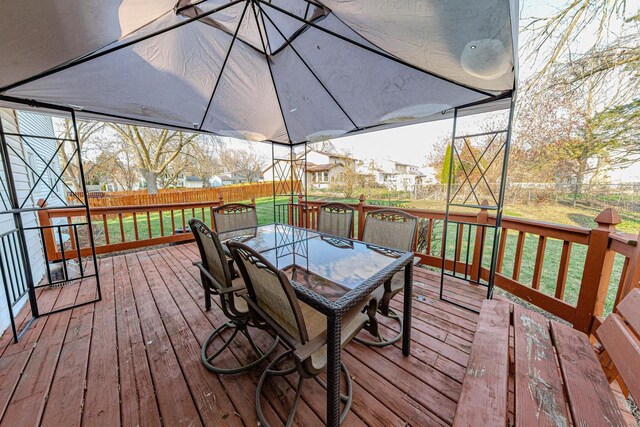 2607 King James Way, Fitchburg, WI 53719 - wooden deck with outdoor dining space, a lawn, and a fenced backyard