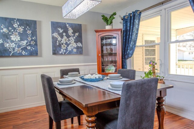 2607 King James Way, Fitchburg, WI 53719 - dining area with an inviting chandelier, wood finished floors, a decorative wall, and wainscoting