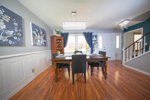 2607 King James Way, Fitchburg, WI 53719 - dining space featuring wainscoting, stairs, wood finished floors, and a chandelier