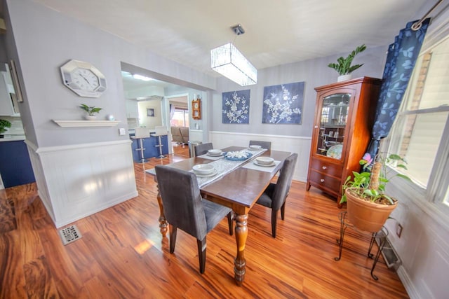 2607 King James Way, Fitchburg, WI 53719 - dining area with visible vents, a wainscoted wall, and wood finished floors