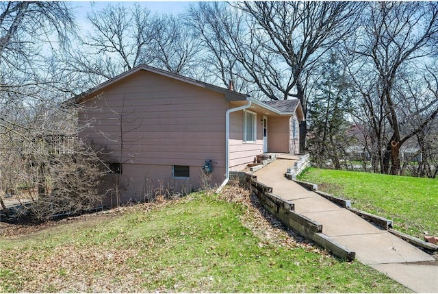 view of side of home featuring a yard