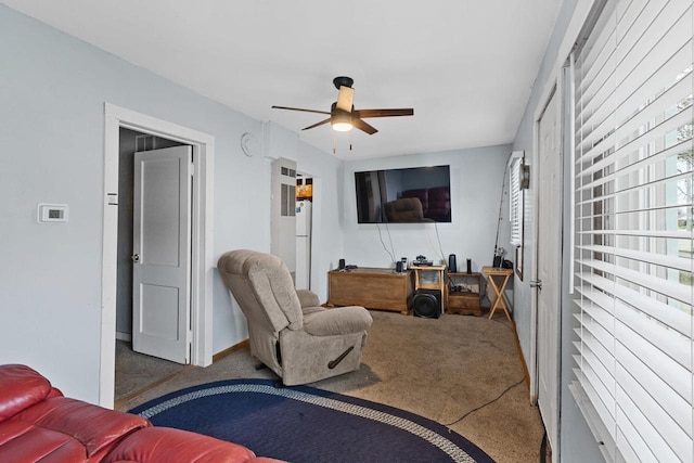 living area featuring carpet floors and ceiling fan