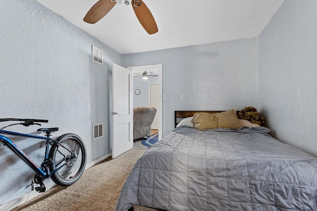 carpeted bedroom with baseboards, visible vents, and ceiling fan