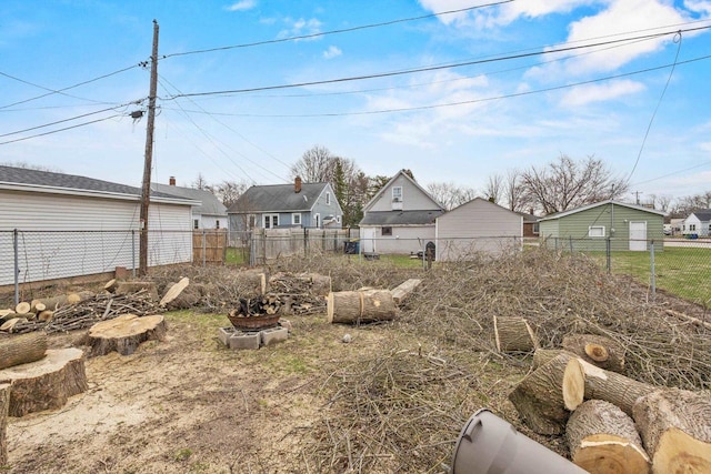 view of yard featuring fence and a residential view