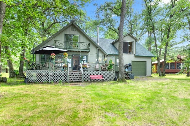 6756 Deer Track Rd, Siren, WI 54872 - back of house featuring a wooden deck, a yard, driveway, and roof with shingles