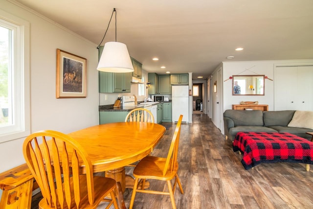 dining space featuring recessed lighting, dark wood-style flooring, and a healthy amount of sunlight