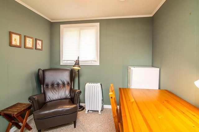 sitting room with baseboards, carpet, ornamental molding, and radiator