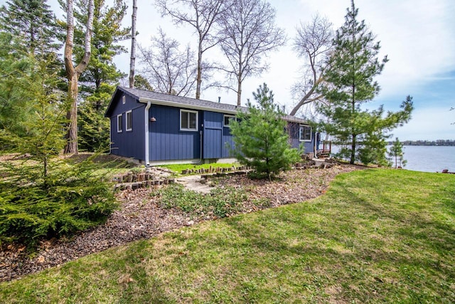 exterior space with a lawn and a water view