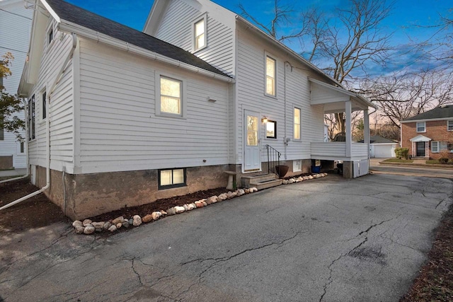 rear view of house with entry steps and a garage