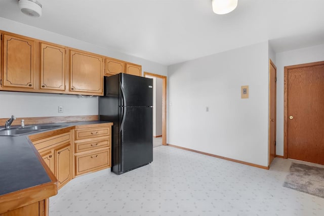 W14390 State Road 23-49, Ripon, WI 54971 - kitchen with light floors, baseboards, a sink, and freestanding refrigerator