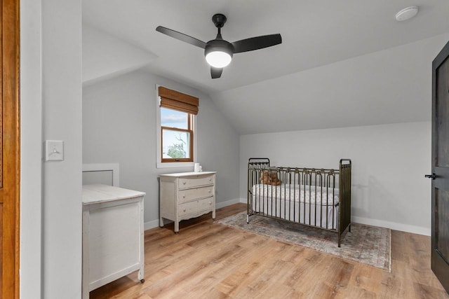 1620 E Murdock Ave, Oshkosh, WI 54901 - bedroom with light wood finished floors, baseboards, lofted ceiling, ceiling fan, and a nursery area