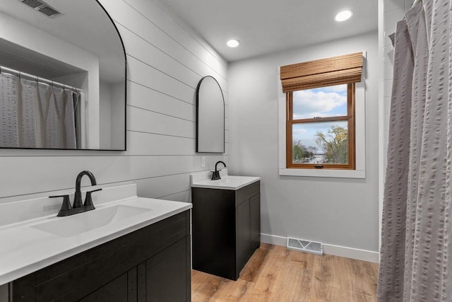 1620 E Murdock Ave, Oshkosh, WI 54901 - bathroom with wood finished floors, visible vents, and a sink