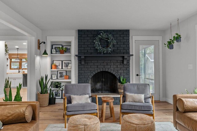 1620 E Murdock Ave, Oshkosh, WI 54901 - living room featuring a fireplace, wood finished floors, and baseboards