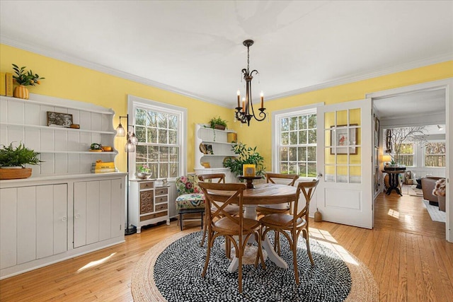 dining area with a wealth of natural light and crown molding