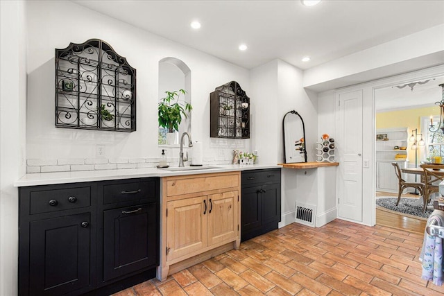 bar featuring recessed lighting, tasteful backsplash, visible vents, and a sink