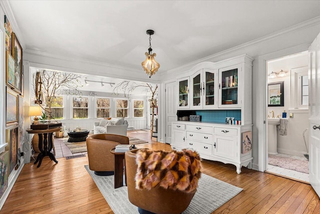 sunroom / solarium with a notable chandelier