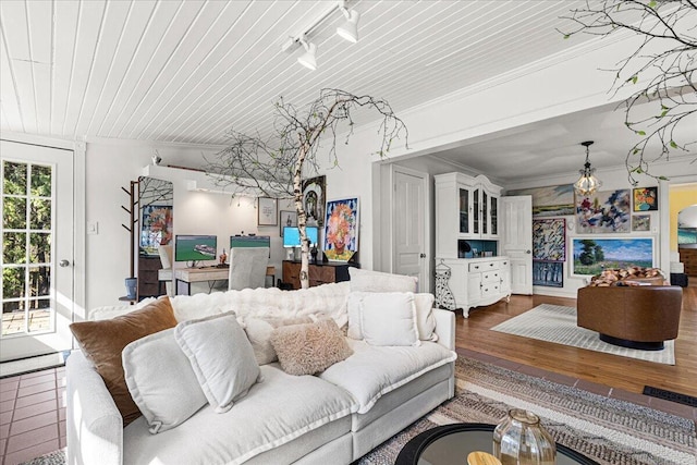 living room featuring wood ceiling, ornamental molding, and wood finished floors