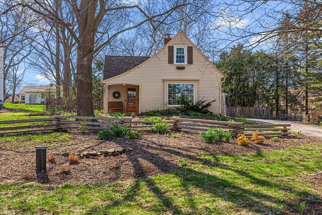 view of front of home with fence and a chimney