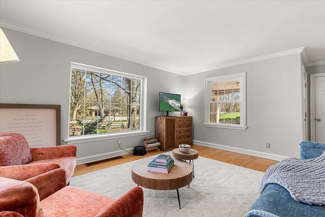 living room featuring baseboards, wood finished floors, and crown molding