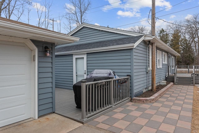 12759 N Shoreland Pkwy, Mequon, WI 53092 - view of side of property with a deck and roof with shingles