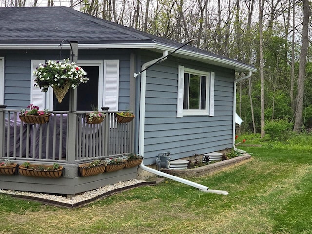 12759 N Shoreland Pkwy, Mequon, WI 53092 - view of side of home with a shingled roof and a lawn