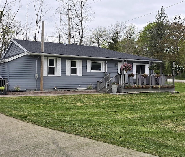 12759 N Shoreland Pkwy, Mequon, WI 53092 - ranch-style house featuring a front yard, a deck, and a shingled roof