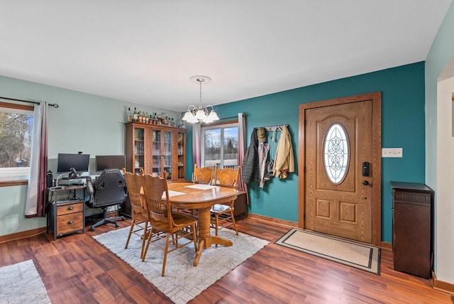12759 N Shoreland Pkwy, Mequon, WI 53092 - dining area featuring a chandelier, healthy amount of natural light, and baseboards