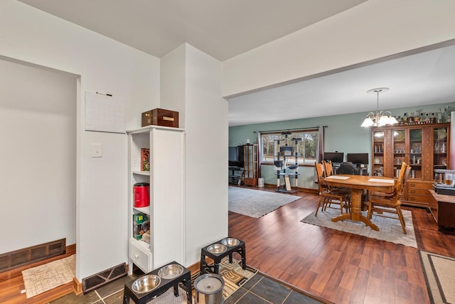 12759 N Shoreland Pkwy, Mequon, WI 53092 - dining space with wood finished floors, a chandelier, and baseboards
