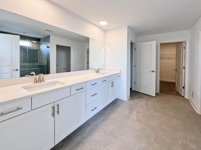 4003 Banbury St, Windsor, WI 53598 - full bathroom featuring a stall shower, a walk in closet, double vanity, and baseboards