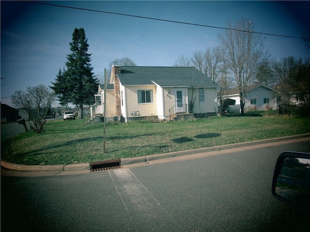 419 Corbett Ave, Ladysmith, WI 54848 - bungalow-style house featuring a chimney and a front lawn