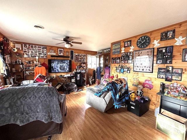 319 Hilltop Ct, Warrens, Warrens, WI 54666 - living area featuring wood finished floors, visible vents, wood walls, and a ceiling fan