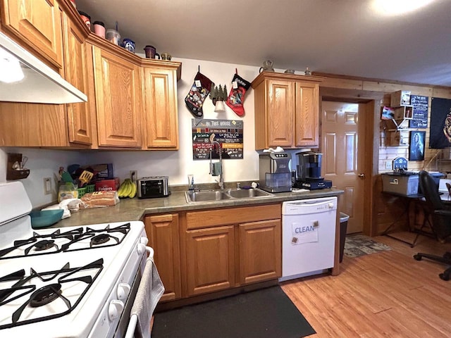 319 Hilltop Ct, Warrens, Warrens, WI 54666 - kitchen with brown cabinets, under cabinet range hood, a sink, white appliances, and light wood-type flooring