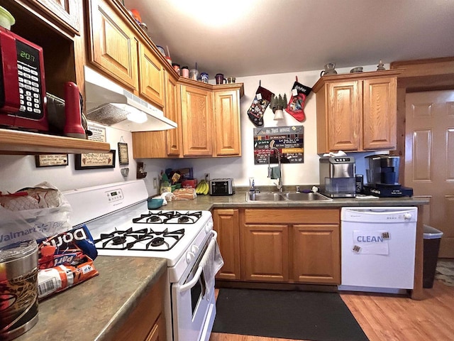 319 Hilltop Ct, Warrens, Warrens, WI 54666 - kitchen with brown cabinets, light wood finished floors, under cabinet range hood, a sink, and white appliances