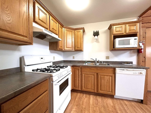319 Hilltop Ct, Warrens, Warrens, WI 54666 - kitchen with dark countertops, under cabinet range hood, a sink, and white appliances