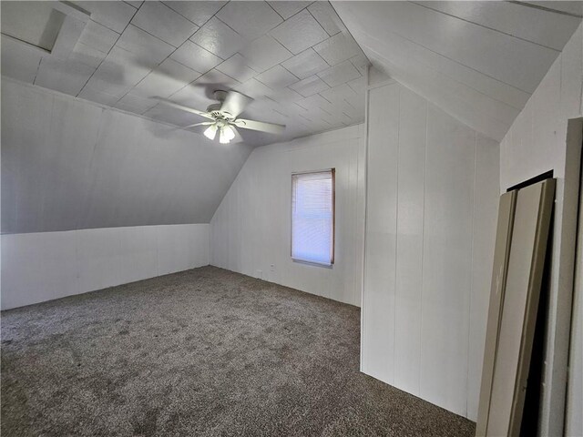 additional living space with a ceiling fan, lofted ceiling, and carpet flooring