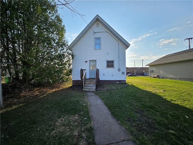 back of property featuring a lawn