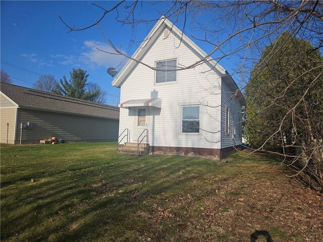 rear view of property with a lawn