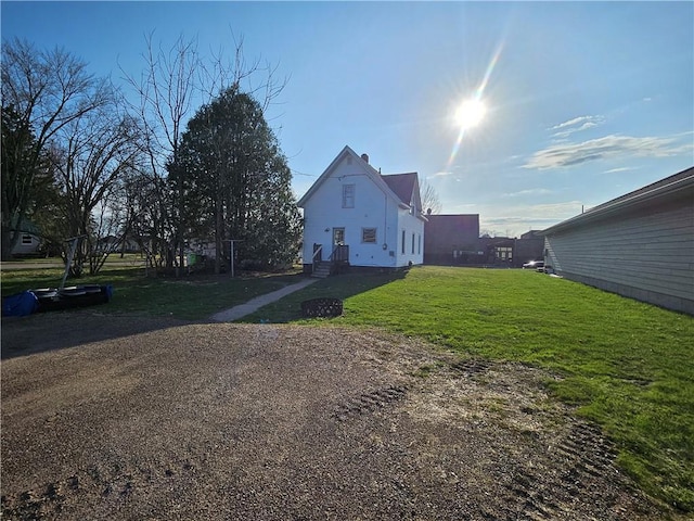 view of home's exterior with a yard and entry steps