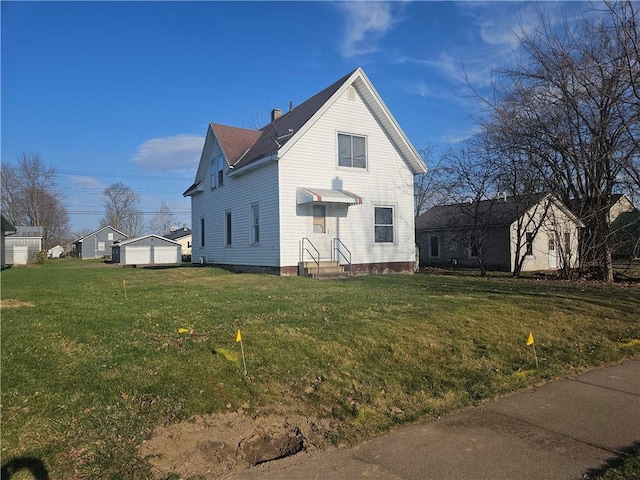 view of home's exterior with a detached garage and a yard